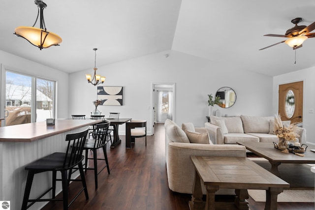 living room featuring lofted ceiling, dark hardwood / wood-style floors, and ceiling fan with notable chandelier