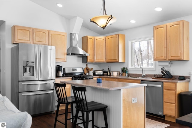 kitchen featuring sink, light brown cabinets, appliances with stainless steel finishes, a kitchen island, and wall chimney range hood