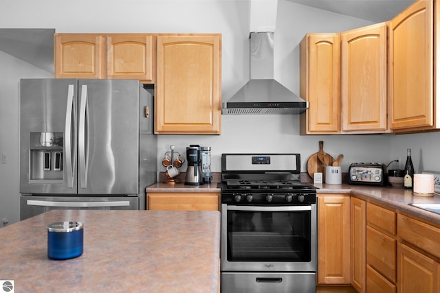 kitchen with light brown cabinetry, wall chimney exhaust hood, and appliances with stainless steel finishes