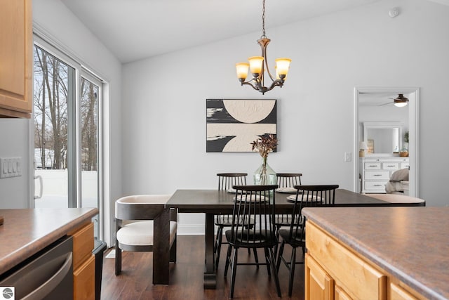 dining area featuring lofted ceiling, dark hardwood / wood-style flooring, and a notable chandelier