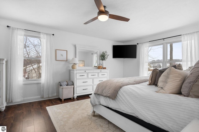 bedroom with dark hardwood / wood-style floors and ceiling fan