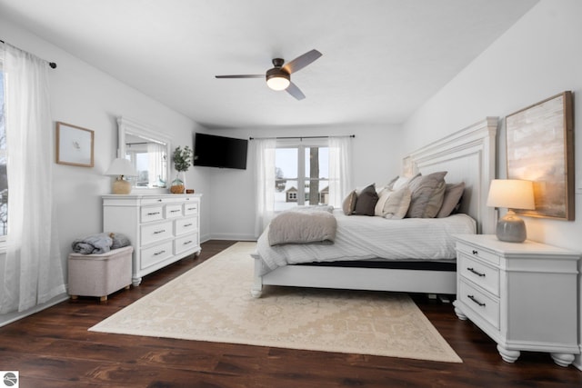 bedroom featuring multiple windows, dark hardwood / wood-style floors, and french doors