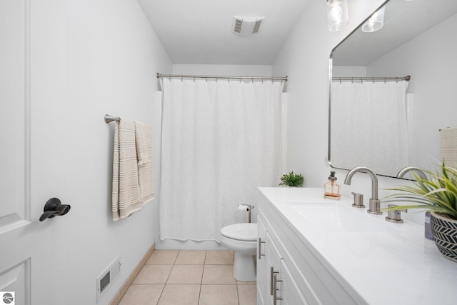 bathroom with vanity, walk in shower, tile patterned floors, and toilet