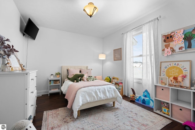 bedroom with dark hardwood / wood-style flooring