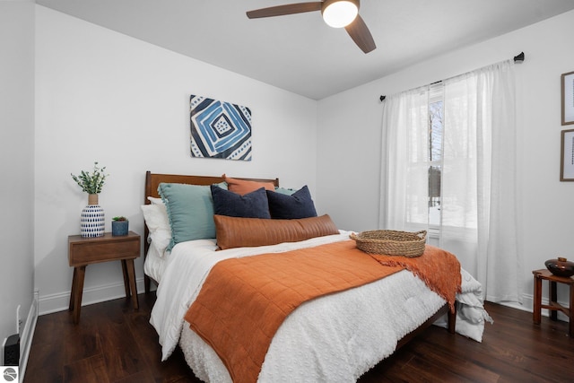 bedroom with dark hardwood / wood-style flooring and ceiling fan