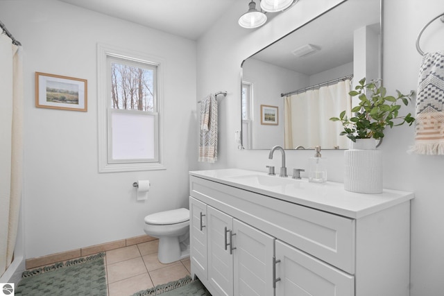 bathroom with tile patterned flooring, vanity, and toilet