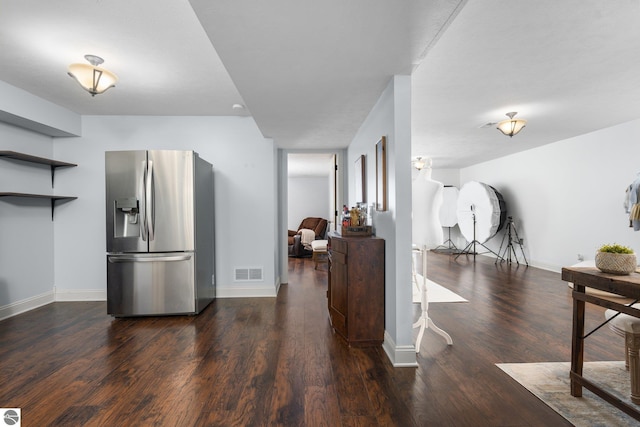 kitchen with dark hardwood / wood-style floors and stainless steel fridge with ice dispenser