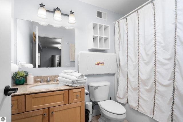 full bathroom featuring vanity, shower / bath combination with curtain, and toilet