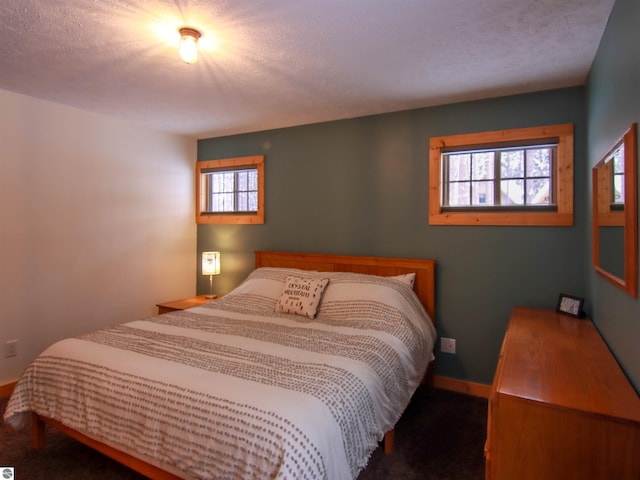 bedroom featuring multiple windows and a textured ceiling