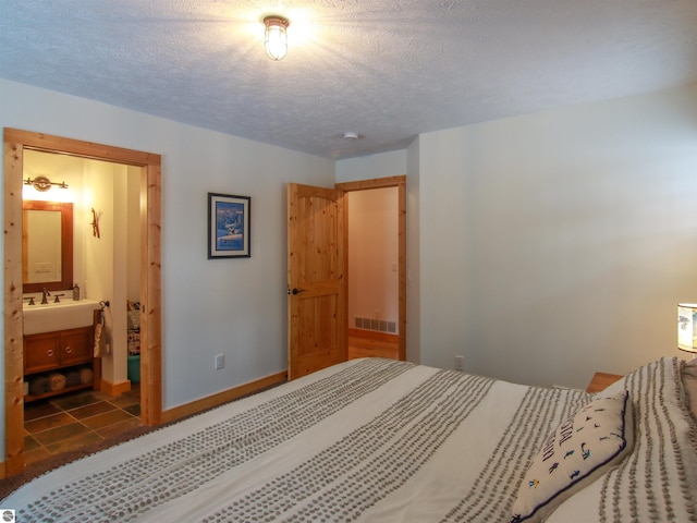 bedroom featuring a textured ceiling