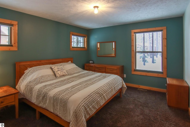 carpeted bedroom featuring a textured ceiling