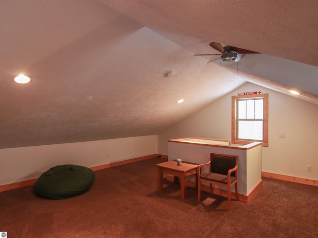 additional living space with ceiling fan, lofted ceiling, a textured ceiling, and dark carpet