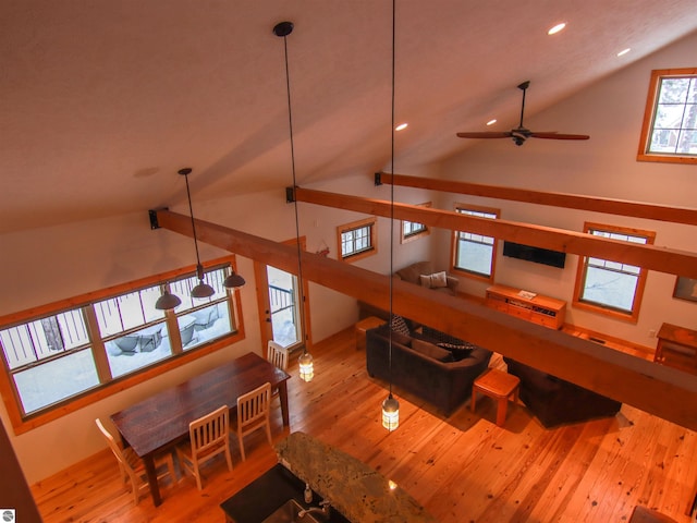 interior space featuring ceiling fan, high vaulted ceiling, and light hardwood / wood-style flooring