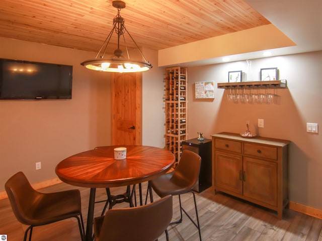 dining area featuring wooden ceiling and light hardwood / wood-style flooring