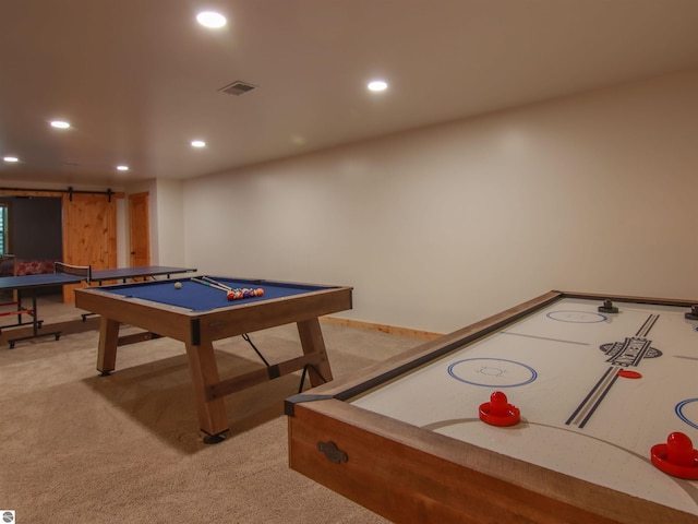 game room with carpet floors and a barn door