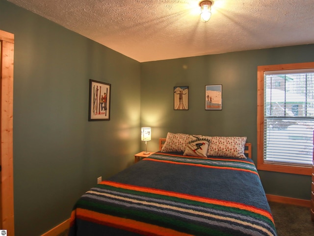 carpeted bedroom with a textured ceiling