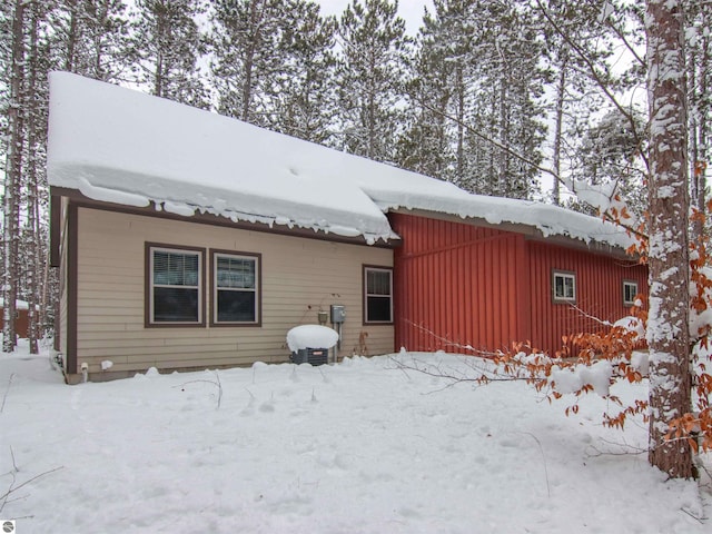 view of snow covered back of property