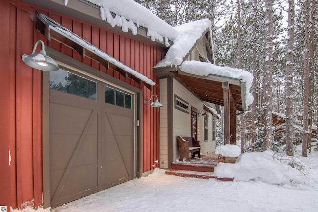 view of snowy exterior with a garage