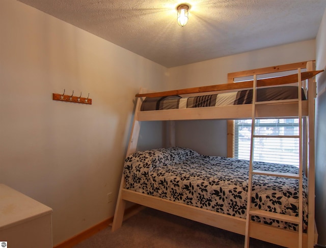 bedroom with carpet flooring and a textured ceiling