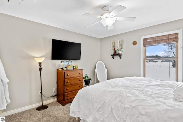 bedroom featuring light colored carpet and ceiling fan