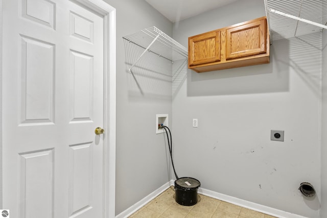 washroom featuring washer hookup, cabinets, and hookup for an electric dryer