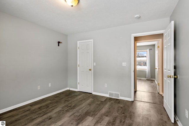 spare room with dark hardwood / wood-style floors