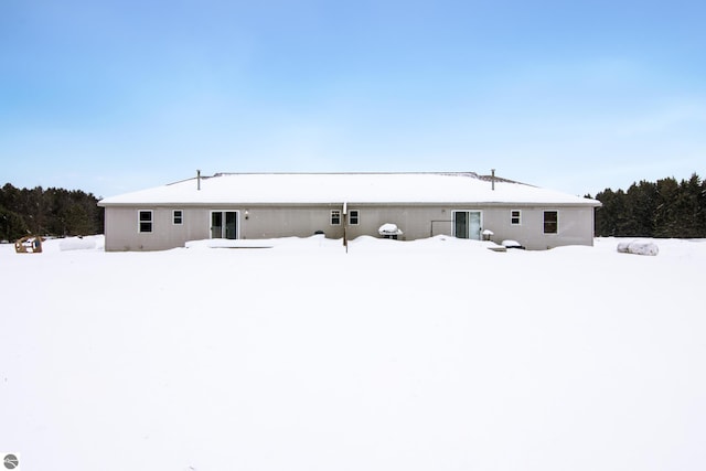 view of snow covered back of property