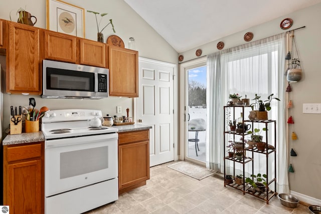 kitchen featuring vaulted ceiling and electric stove