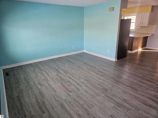 spare room with dark hardwood / wood-style floors