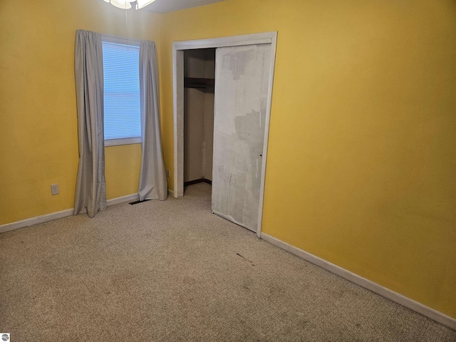 unfurnished bedroom featuring carpet floors and a closet