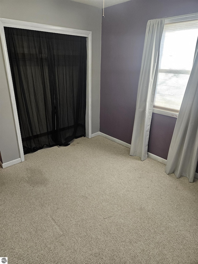 spare room featuring light colored carpet