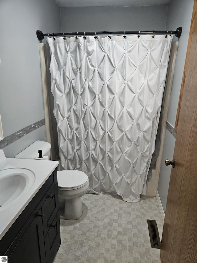 full bathroom featuring vanity, toilet, and shower / bath combo with shower curtain