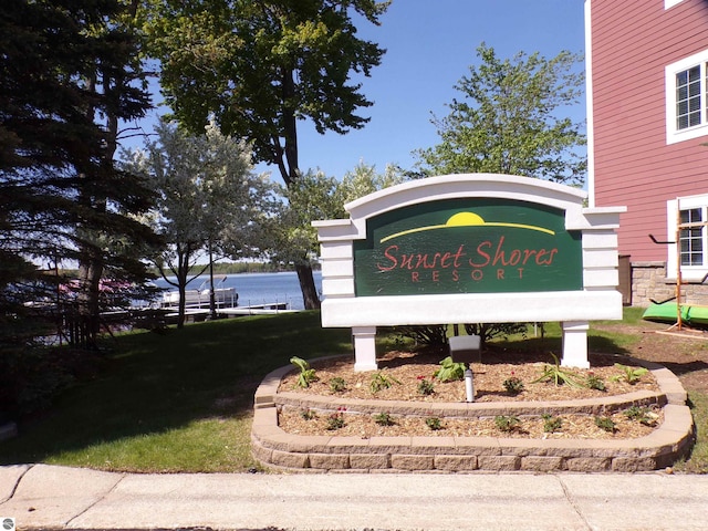 community / neighborhood sign featuring a water view