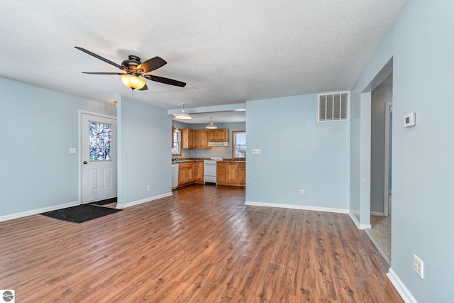 unfurnished living room with wood-type flooring, ceiling fan, and a textured ceiling