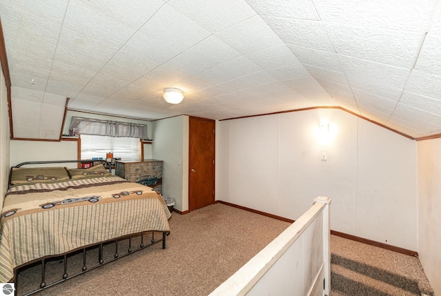 carpeted bedroom featuring vaulted ceiling and a textured ceiling