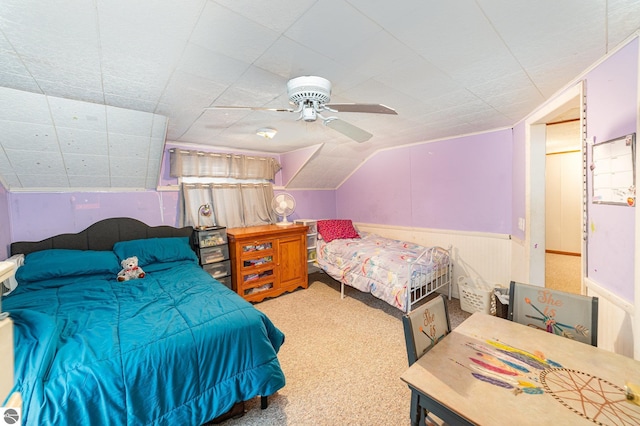 carpeted bedroom featuring lofted ceiling and ceiling fan