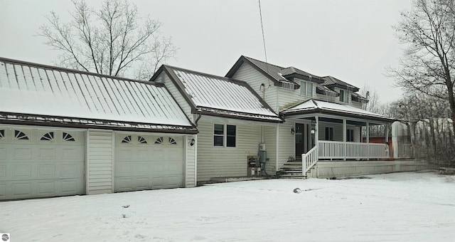 view of front of home with a porch and a garage