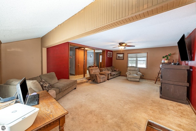 carpeted living room with ceiling fan and a textured ceiling