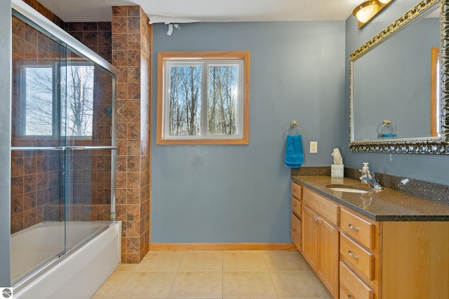 bathroom with tile patterned flooring, vanity, and combined bath / shower with glass door