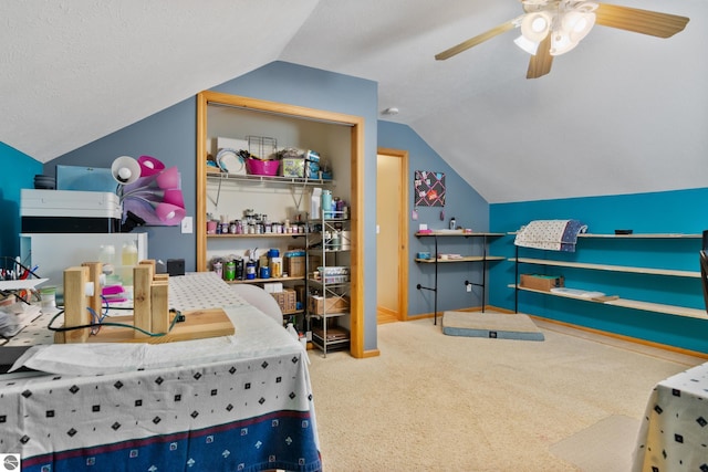 bedroom with ceiling fan, lofted ceiling, and carpet