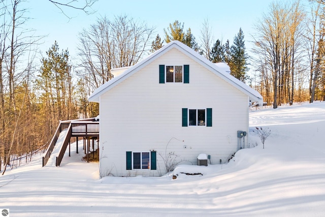 snow covered property featuring a deck