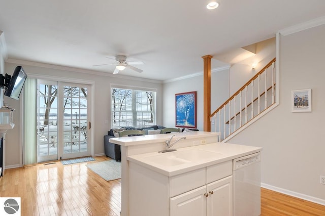 kitchen featuring a kitchen island, white cabinetry, dishwasher, sink, and ornamental molding