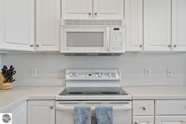 kitchen with white cabinetry and white appliances