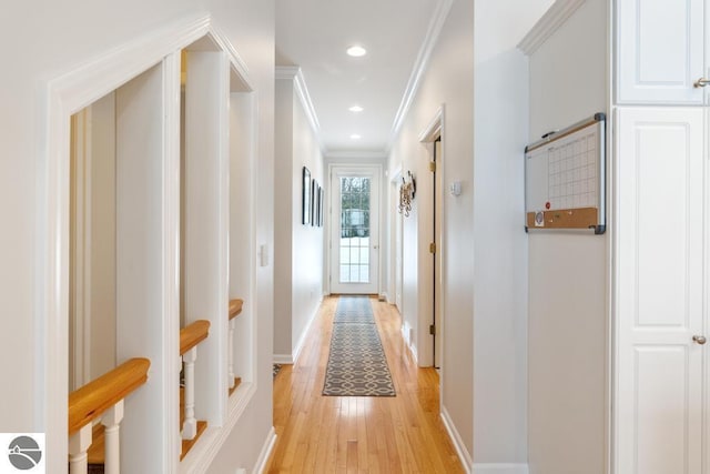 hall featuring crown molding and light hardwood / wood-style flooring