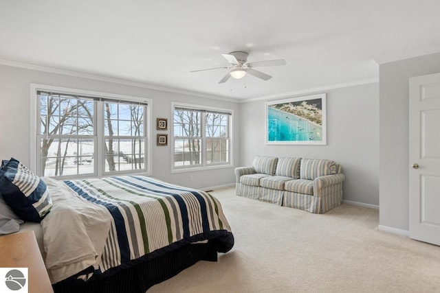 carpeted bedroom featuring ceiling fan and ornamental molding