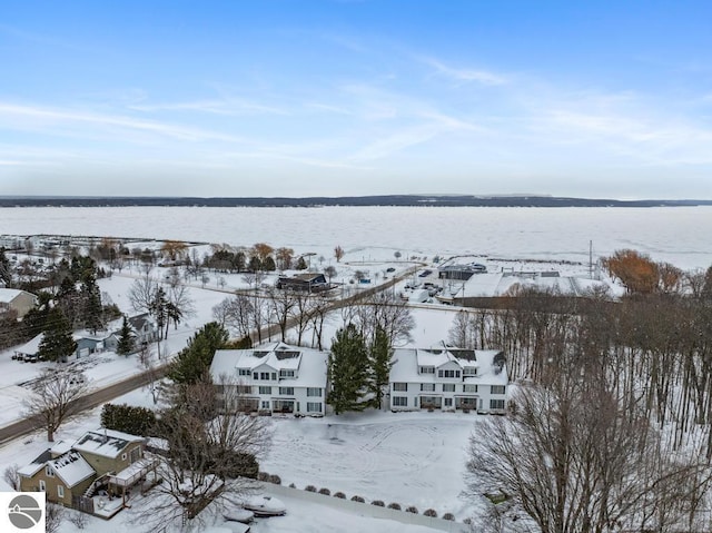 snowy aerial view with a water view