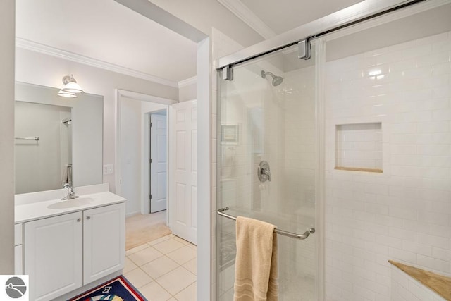 bathroom with tile patterned flooring, ornamental molding, an enclosed shower, and vanity