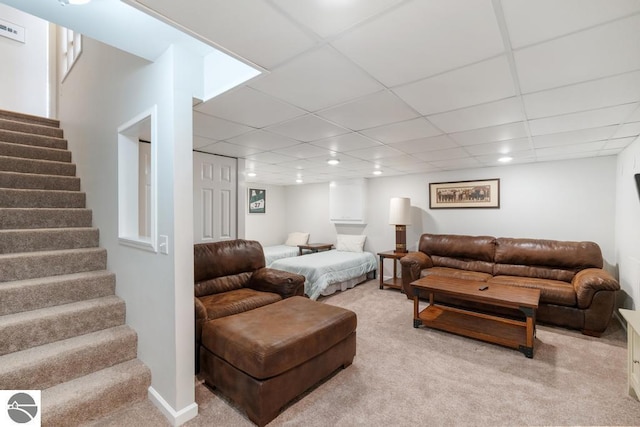 living room featuring a paneled ceiling and light colored carpet