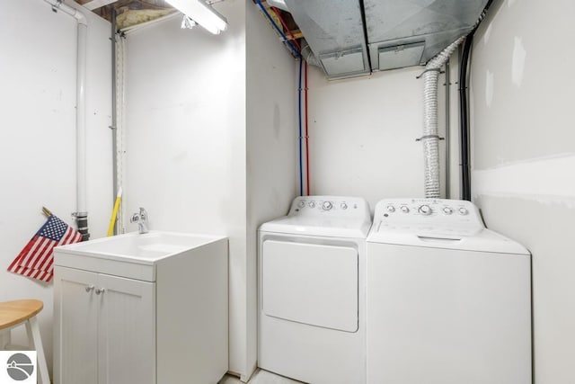 washroom with washer and clothes dryer and sink