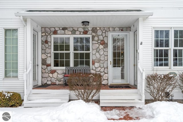 view of snow covered property entrance